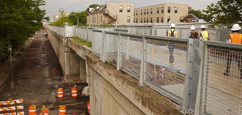 Photo of people walking on elevated Bloomingdale Trail and street below